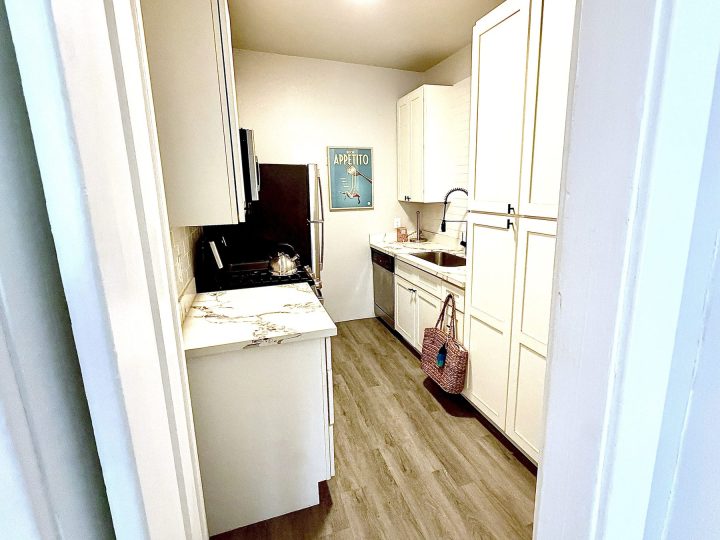 Renovated kitchen with quartz countertops and stainless steel appliances