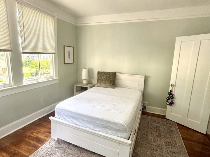 Bedroom with a bed, nightstand and hardwood floors