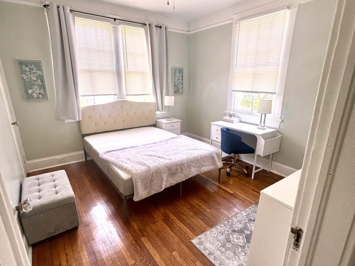 Primary bedroom with a bed, desk and upholstered bench