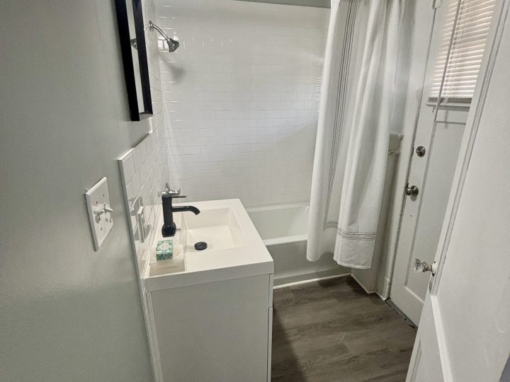 Walk-in shower with a pedestal-style vanity