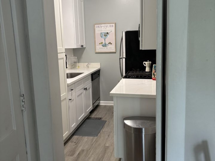 Kitchen viewed from the hallway with stainless refrigerator