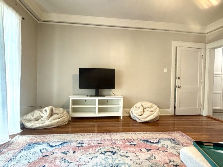 Living room with a television console and layered rug