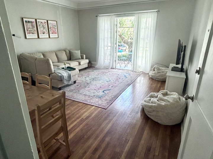 Living room with a wooden dining table beside the seating area