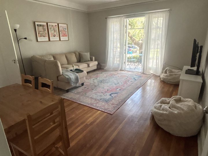 Living and dining space with windows to the balcony