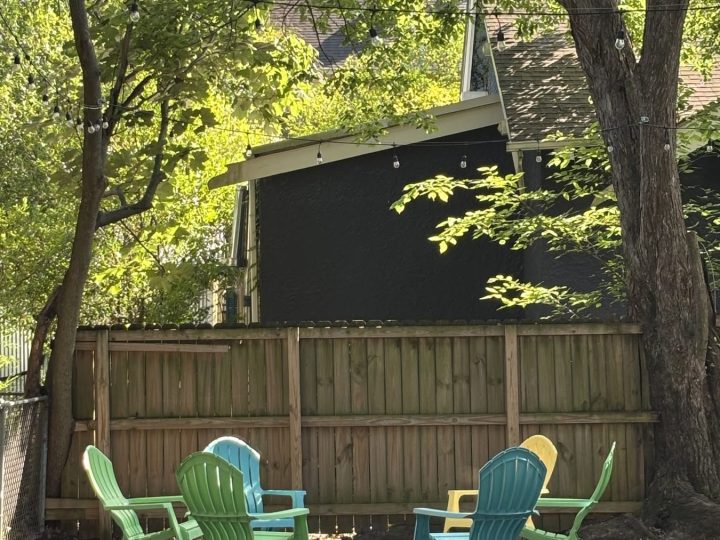 Shaded patio with Adirondack chairs under hundred-year-old oaks