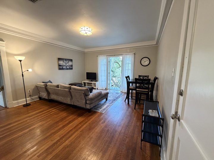 Living room with a grey corduroy sofa and French doors