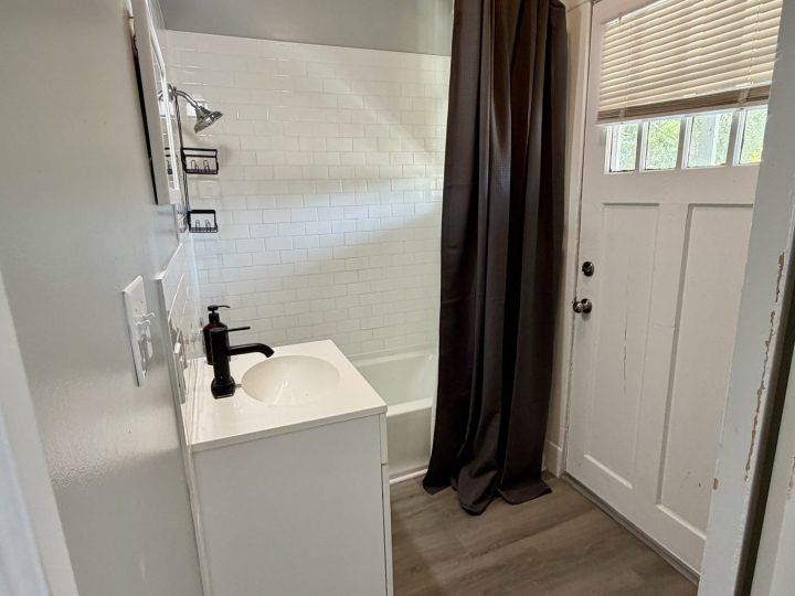 Second bathroom with a walk-in shower and exterior door