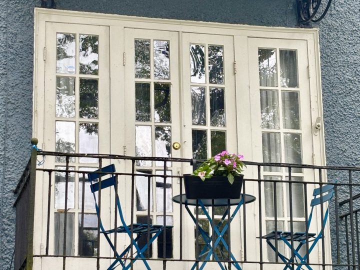 Private balcony with a blue French bistro set